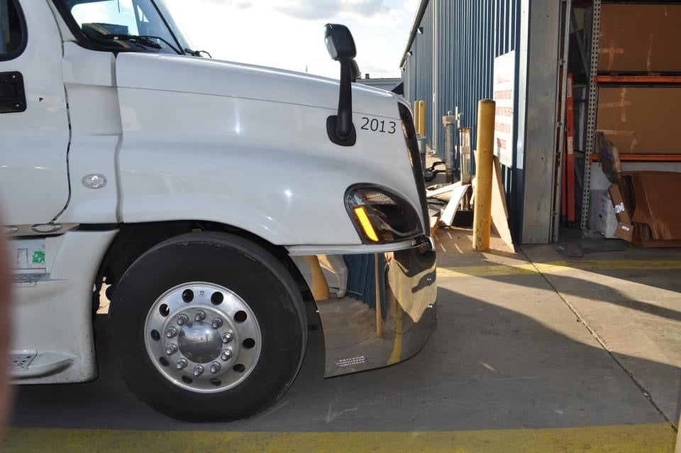 Freightliner Cascadia 18" stainless steel wraparound bumper w/ center grill cutout & tow holes, 9 oval light holes