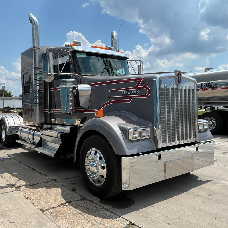 Large truck on a concrete surface with a blue sky in the background