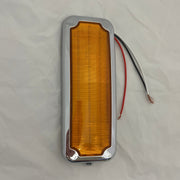 Amber rectangular light with silver frame on a white background