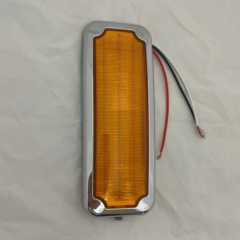 Amber rectangular light with silver frame on a white background