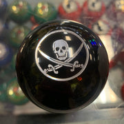 Round black gear shift knob with a silver skull and crossbones design