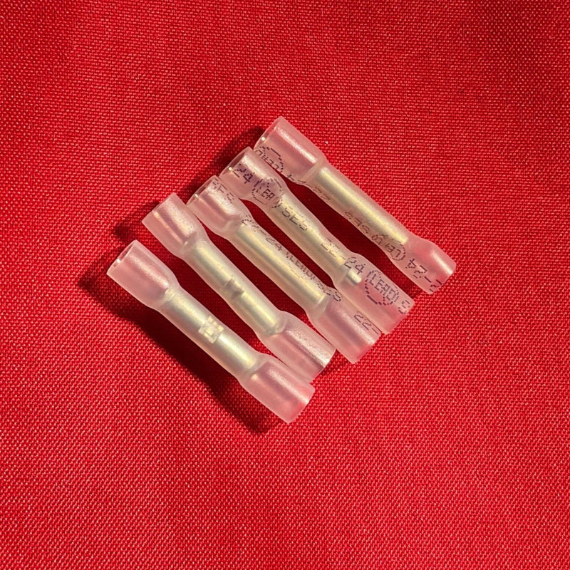 Set of five clear electrical connectors on a red background