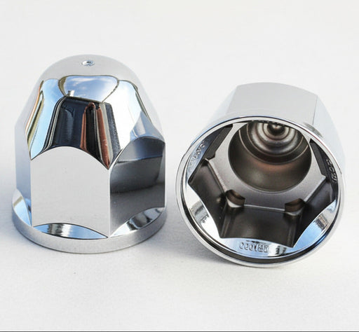 Two chrome plastic lugnut covers, one displayed in an upright position and the other on its side revealing the internal spring-clip mechanism.